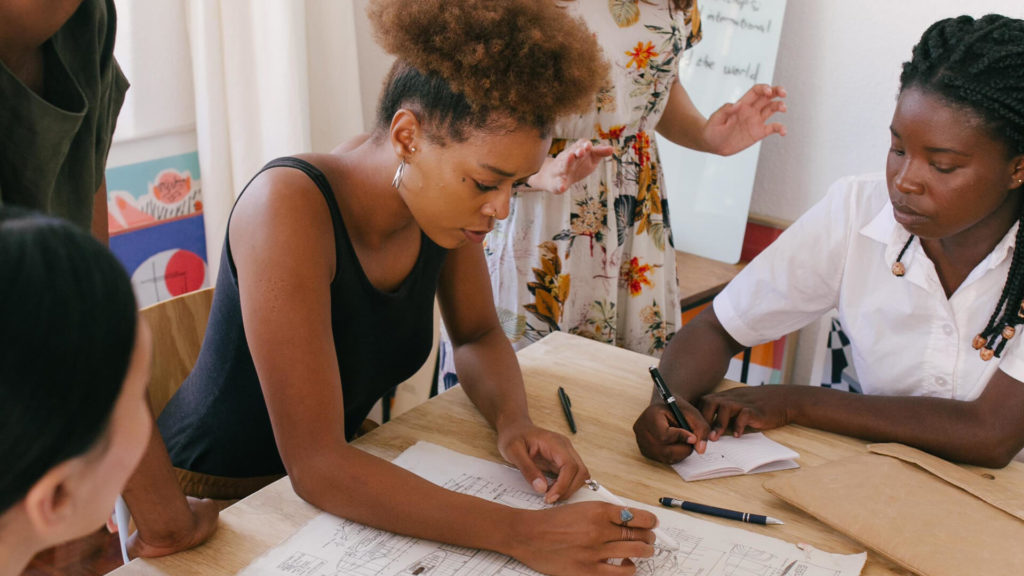 Women at a table strategizing | Nonprofit Charity Marketing Insights | Anchor Marketing Inc.