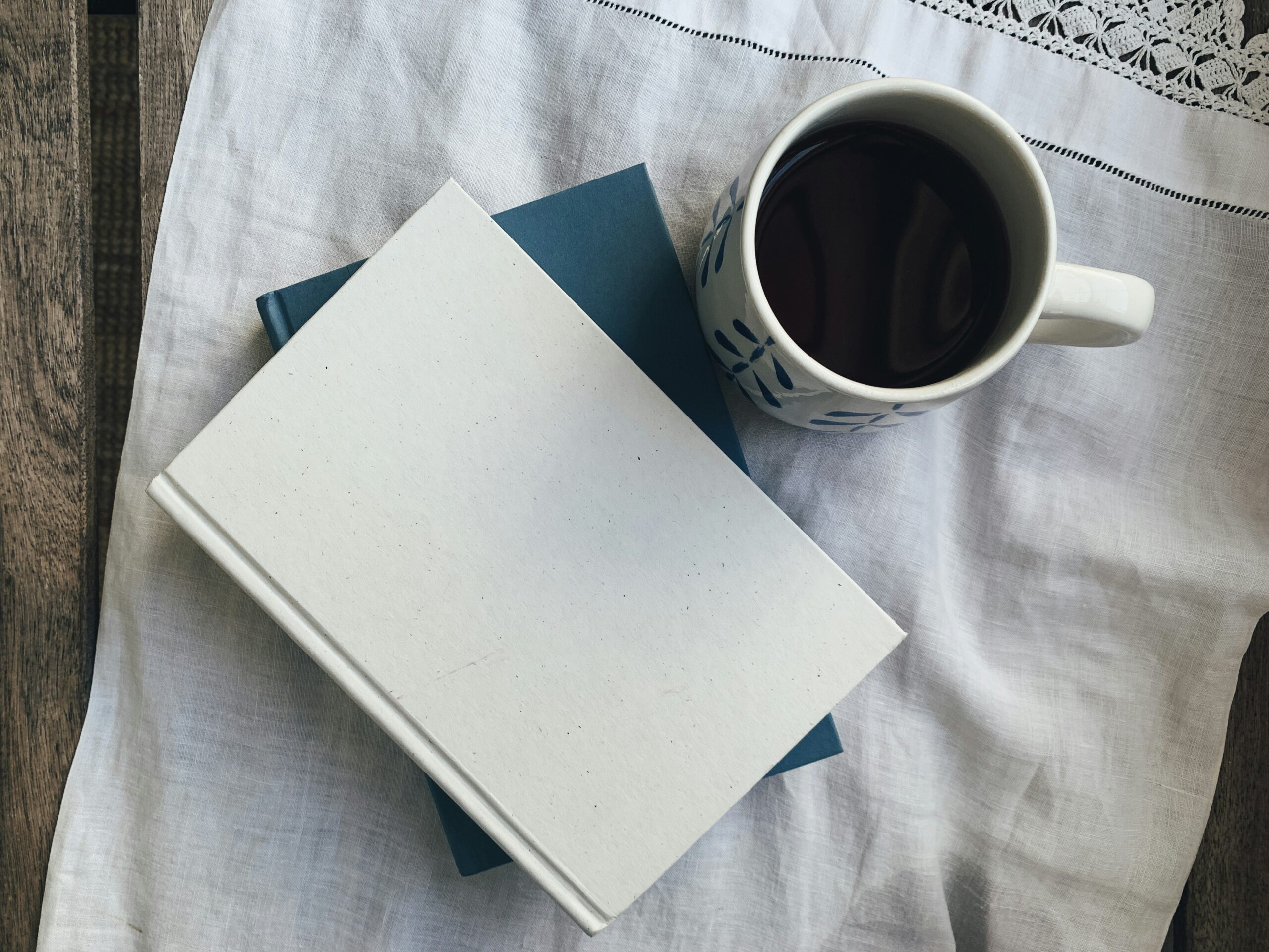 A coffee mug and a journal laid out - a week of content ideas for Mental Health Week, designed for nonprofit and charity marketing efforts.